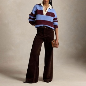 Model wearing Polo Ralph Lauren Harvardwne stripe rugby knit sweater, styled with wide-leg brown corduroy trousers and white collar underneath