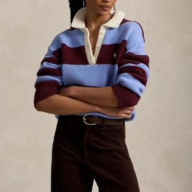 Model wearing Polo Ralph Lauren Harvardwne striped knit polo, styled with dark brown wide-leg trousers and a belt.
