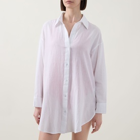 Model wearing Sea Level Vacay Cruise Shirt in white, featuring point collar, long sleeves, front button fastening and curved hem.