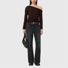 Model wearing All Saints brown flock one-shoulder long-sleeve top, styled with dark wash wide-leg jeans, black belt and shoulder bag.