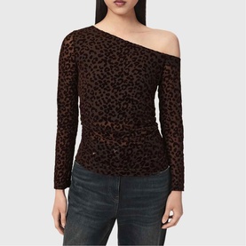 Model wearing All Saints brown flock leopard print one-shoulder long sleeve top, styled with dark wash jeans.