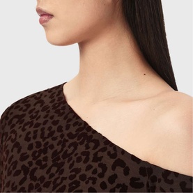 Model wearing All Saints brown flock leopard-print asymmetric one-shoulder top, close-up neckline detail view