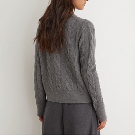 Model wearing Reiss charcoal grey cable-knit jumper, back view, styled with grey wide-leg trousers