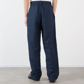 Model wearing Jacquemus dark navy casual trousers, elasticated waist, wide leg fit, shown from behind.