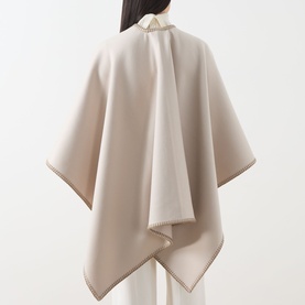 Model wearing Max Mara Accessories camel virgin wool cape, rear view, with contrast stitch trim detail along edges