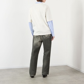 Model wearing Pellador Swan Logo T-Shirt in white, styled over blue long-sleeve shirt with grey wide-leg trousers. Rear view.