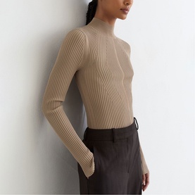 Model wearing Reiss beige ribbed knit mock-neck long sleeve top, styled with dark brown tailored trousers.