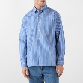 Model wearing A.P.C. blue grey striped cotton casual shirt with chest pocket, styled with light wash denim jeans