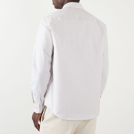 Model wearing A.P.C. beige cotton casual shirt, rear view, styled with cream trousers