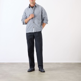 Model wearing A.P.C. blue grey cotton casual shirt, styled with dark trousers and black leather shoes.
