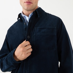 Model wearing A.P.C. Patch Pocket Corduroy Shirt in dark navy, featuring front button fastening and chest patch pocket, styled over a light blue