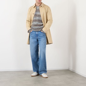 Model wearing A.P.C. grey mohair-alpaca crew neck jumper with striped pattern, styled with beige coat and wide-leg blue jeans.