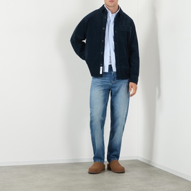 Model wearing A.P.C. Martin Straight-Leg Jeans in washed indigo, styled with a navy jacket, light blue shirt and tan suede loafers.