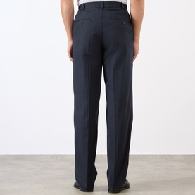 Model wearing A.P.C. dark navy cotton jeans, rear view showing straight-leg fit, back pockets and belt loops.
