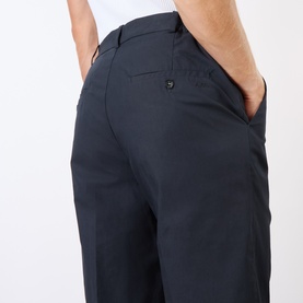 Model wearing A.P.C. dark navy cotton jeans, close-up of rear pocket and relaxed straight-leg fit