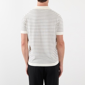 Model wearing A.P.C. natural cotton striped T-shirt, back view, styled with black trousers