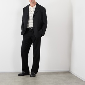 Model wearing A.P.C. natural stripe cotton T-shirt, styled with black blazer, tailored trousers, and black loafers.