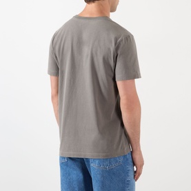 Model wearing A.P.C. T-shirt in Gris Tahiti, back view, 100% cotton crew neck tee, styled with blue jeans.