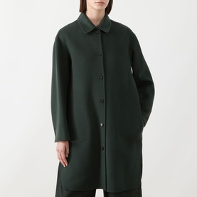 Model wearing Max Mara S emerald wool coat with shirt collar, button-front fastening and relaxed longline silhouette.