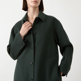 Model wearing Max Mara S emerald wool coat with classic collar and concealed button fastening, oversized silhouette.