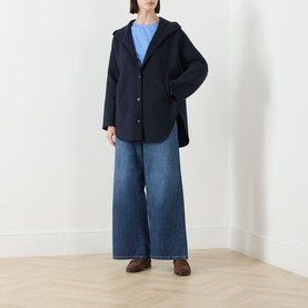 Model wearing Max Mara S Midnight Blue virgin wool hooded coat, styled with light blue top, wide-leg jeans and brown loafers