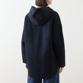 Model wearing Max Mara S Midnight Blue wool hooded coat, shown from behind, styled with wide-leg blue trousers