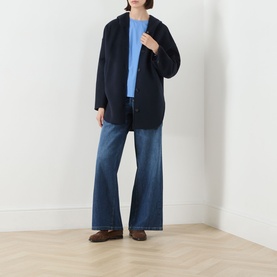 Model wearing Max Mara S Midnight Blue virgin wool coat, styled with a light blue top, wide-leg jeans and brown loafers.
