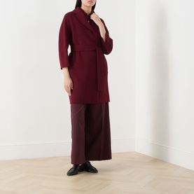 Model wearing Max Mara S bordeaux virgin wool belted coat with wide-leg trousers and black flat shoes.