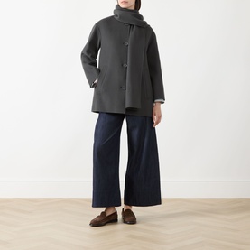 Model wearing Max Mara S dark grey virgin wool coat with button front, styled with navy wide-leg trousers, grey scarf and brown loafers.