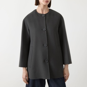 Model wearing Max Mara S dark grey virgin wool collarless coat with large buttons and relaxed silhouette