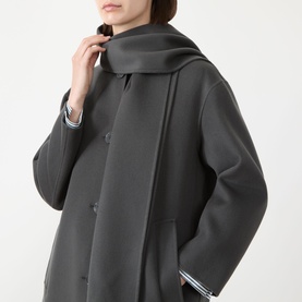 Model wearing Max Mara S dark grey virgin wool coat with attached scarf detail and button front, styled with striped cuffs visible at sleeve hem