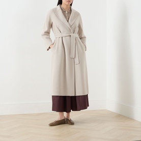 Model wearing Max Mara S Esturia Belted Wrap Coat in beige with notched lapels and self-fabric belt, styled with burgundy wide-leg trousers and khaki