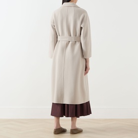 Model wearing Max Mara S Esturia Belted Wrap Coat in beige, back view, longline silhouette with self-fabric belt, styled with burgundy pleated skirt