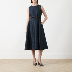 Model wearing Max Mara S midnight blue jacquard midi dress with A-line skirt and black belt, styled with black heels.