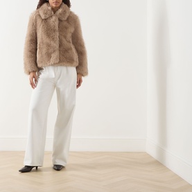 Model wearing Max Mara S Malce Faux-Fur Short Coat in Honey with shirt collar, styled with white wide-leg trousers and black kitten heels