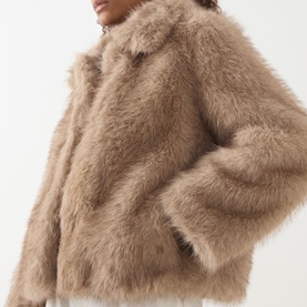 Model wearing Max Mara S Malce Faux-Fur Short Coat in honey, showing fluffy texture, wide fit and shirt collar detail.