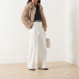 Model wearing Max Mara S Malce Faux-Fur Short Coat in Honey, styled with white wide-leg trousers, navy top, and carrying a beige bag.