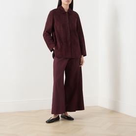 Model wearing Max Mara S Gocce Suede Jacket in red with matching wide-leg trousers and black flat mules