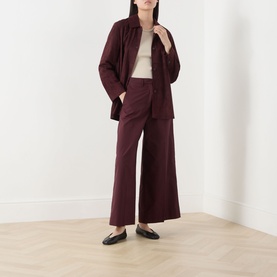 Model wearing Max Mara S Gocce Suede Jacket in red with matching wide-leg trousers and cream top, styled with black mules