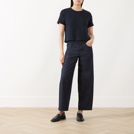 Model wearing Max Mara S Midnight Blue cotton jeans with wide-leg fit, styled with a navy crop tee and black loafers.