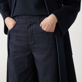 Model wearing Max Mara S Midnight Blue wide-leg jeans in 100% cotton, styled with a matching navy longline coat.