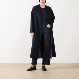Model wearing Max Mara S Midnight Blue jeans styled with a navy longline coat and black loafers.