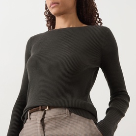 Model wearing Max Mara S Disegno Ribbed-Knit Sweater in kaki, boat neck, long sleeves, styled with checked trousers and brown belt.