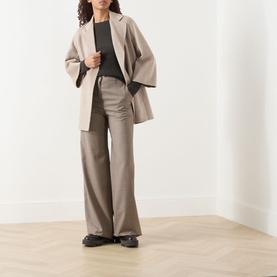Model wearing Max Mara S Disegno Ribbed-Knit Sweater in kaki, styled with taupe wide-leg trousers, matching blazer and black loafers