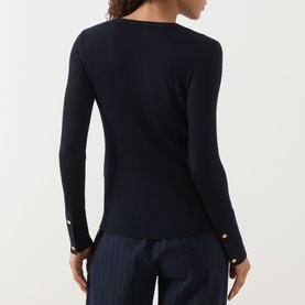 Model wearing Max Mara S Disegno Ribbed-Knit Sweater in ultramarine with gold jewel buttons at cuffs, styled with wide-leg trousers. Rear view.