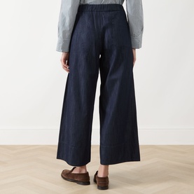 Model wearing Max Mara S Jour Wide-Leg Joggers in Midnight Blue denim, elasticated waist, wide-leg crop cut, styled with brown loafers