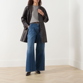 Model wearing Max Mara S Giulietta Light Grey slim fit sweater, styled with dark leather coat and wide-leg blue jeans.