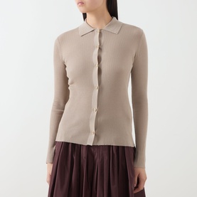 Model wearing Max Mara S Limone Knitted Polo Shirt in beige ribbed wool, with long sleeves and button front, styled with a dark plum pleated skirt.