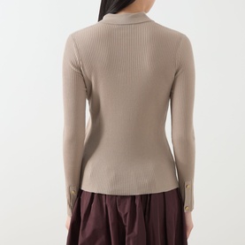 Model wearing Max Mara S Limone Knitted Polo Shirt in beige, back view, ribbed texture, long sleeves with button cuffs, styled with burgundy skirt.