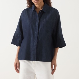 Model wearing Max Mara S Rugiada Chambray Boxy Shirt in Midnight Blue, cropped sleeves, patch pocket, boxy fit, styled with white trousers